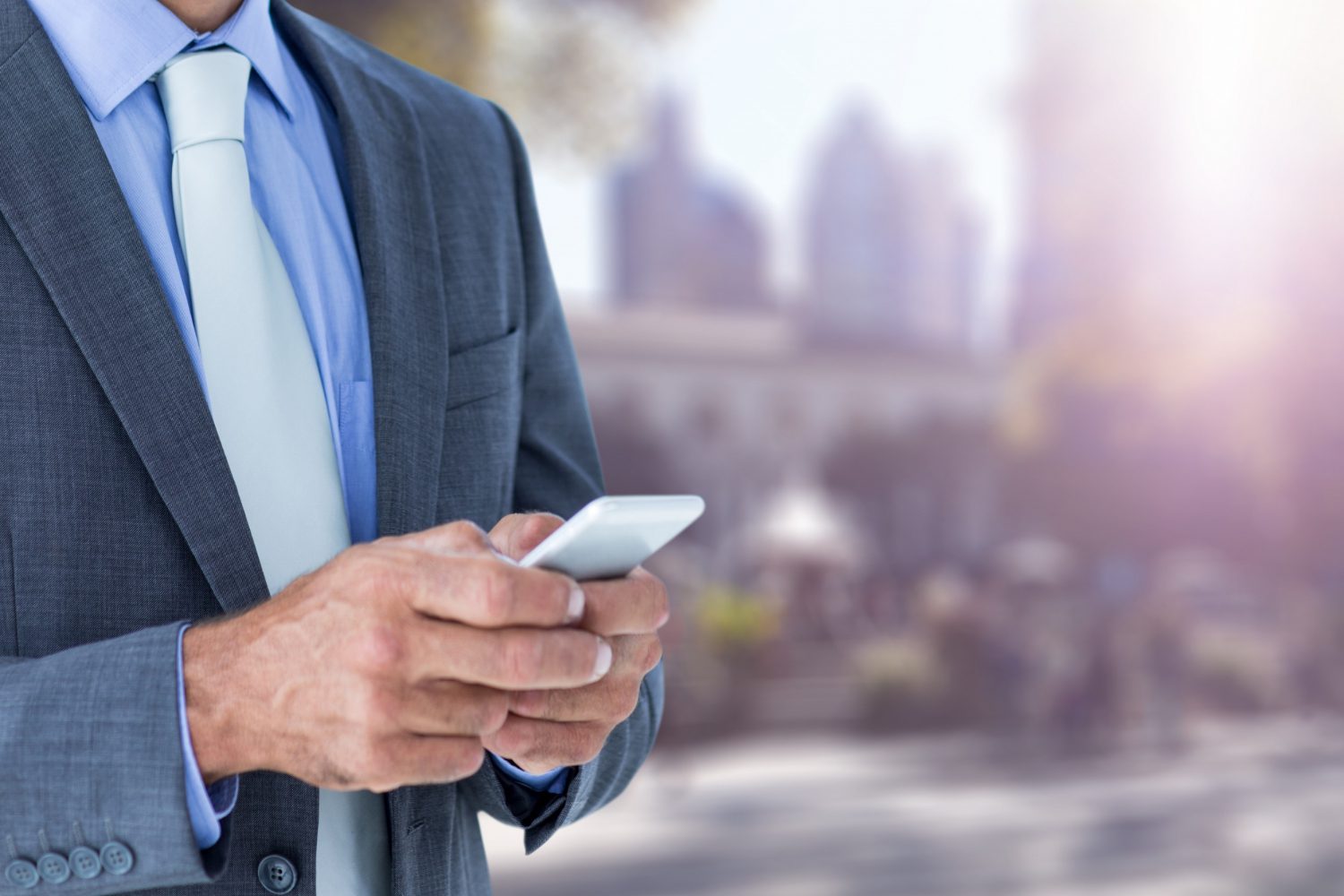 Close-up of businessman using his smartphone<br />
